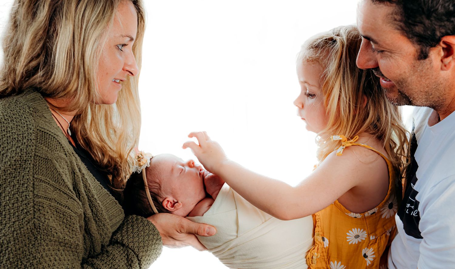 Candid family lifestyle photos showing tender moments in natural light.