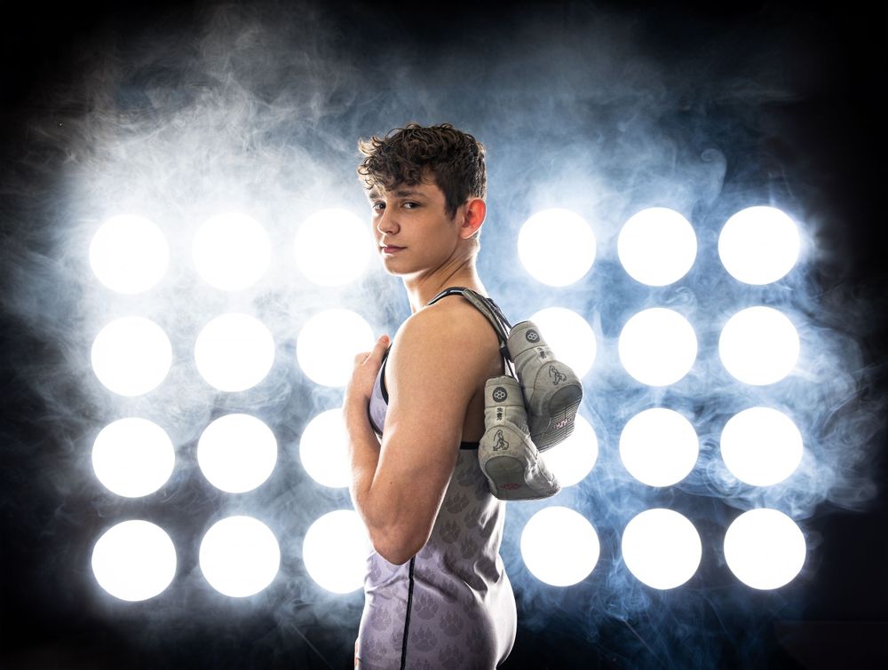 Athletic figure in dramatic lighting with spotlights creating dramatic silhouette effect.