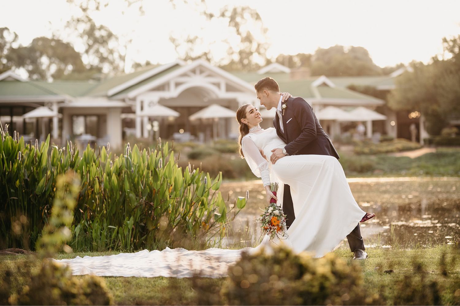Couple laughing and in love with their reflection in the windows at Rolling Waters Country Estate & Swanlake Corner in South Africa