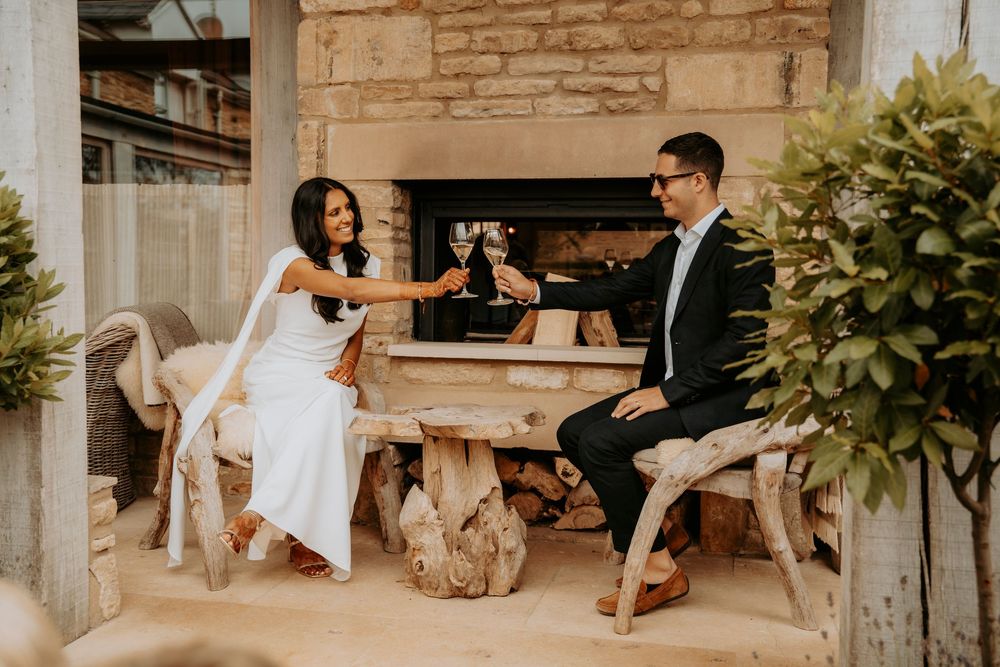 Elegant wedding detail shots showing shoes, rings, and decor arranged in rustic stone venue setting.