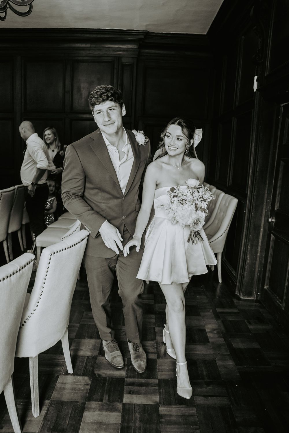Black and white photos of wedding party dancing and posing in formal attire.