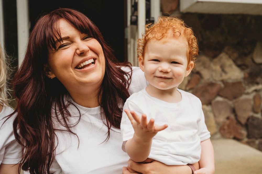Heartwarming outdoor portrait capturing genuine smiles and laughter on stone porch.