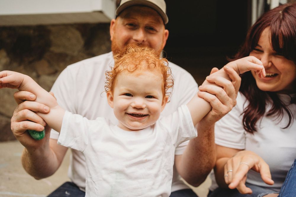 A joyful family moment captured outdoors on a stone porch.