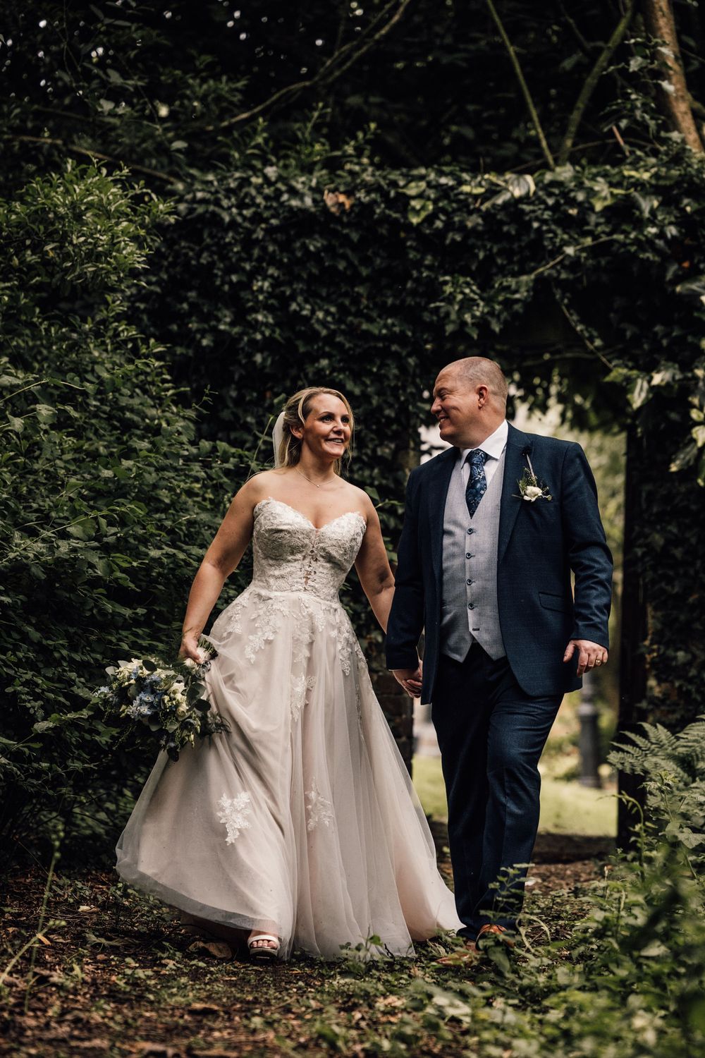Romantic wedding portraits in a lush garden setting with natural lighting.