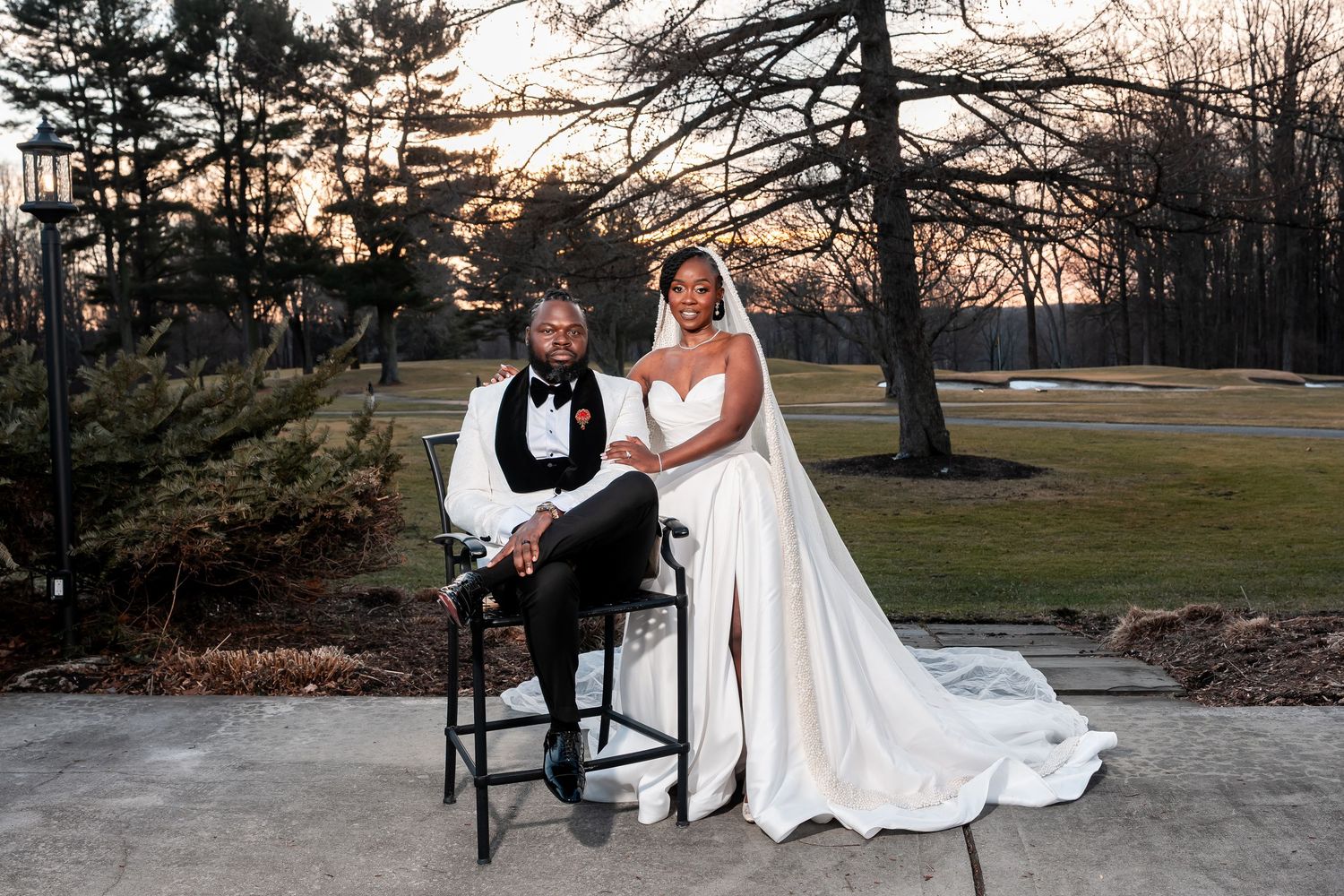 Elegant bride and groom pose outdoors at sunset on a golf course in formal wedding attire. Deerfield Golf Club Newark De