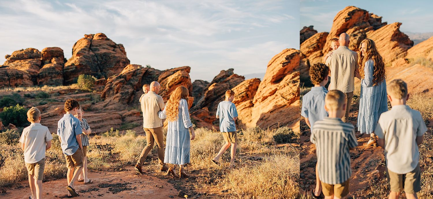 Large family group walks among red rock formations in a desert setting.