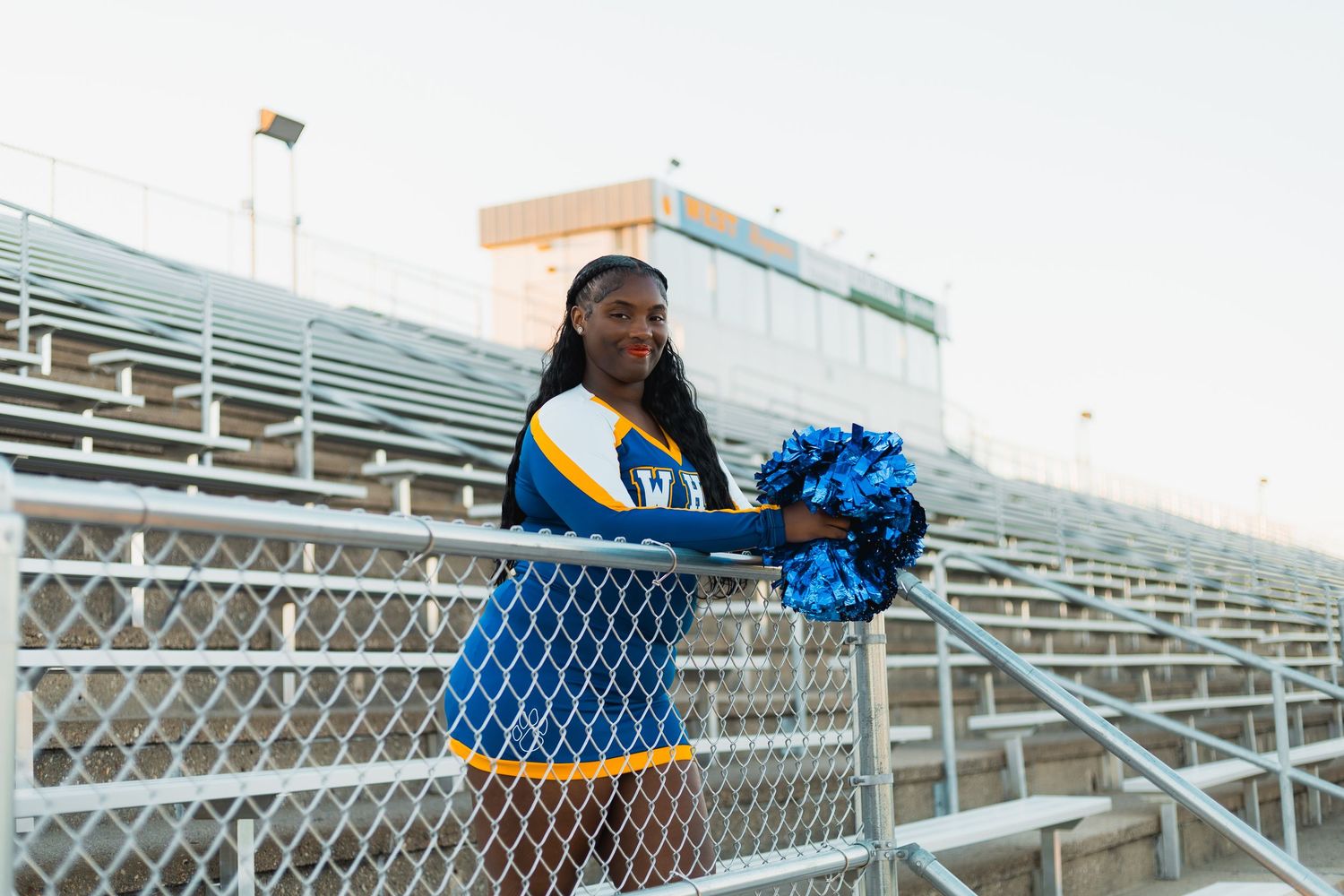 what to wear senior yearbook photos inspiration professional photographer madison wi advice tips tricks cheerleader blue gold poms bleachers