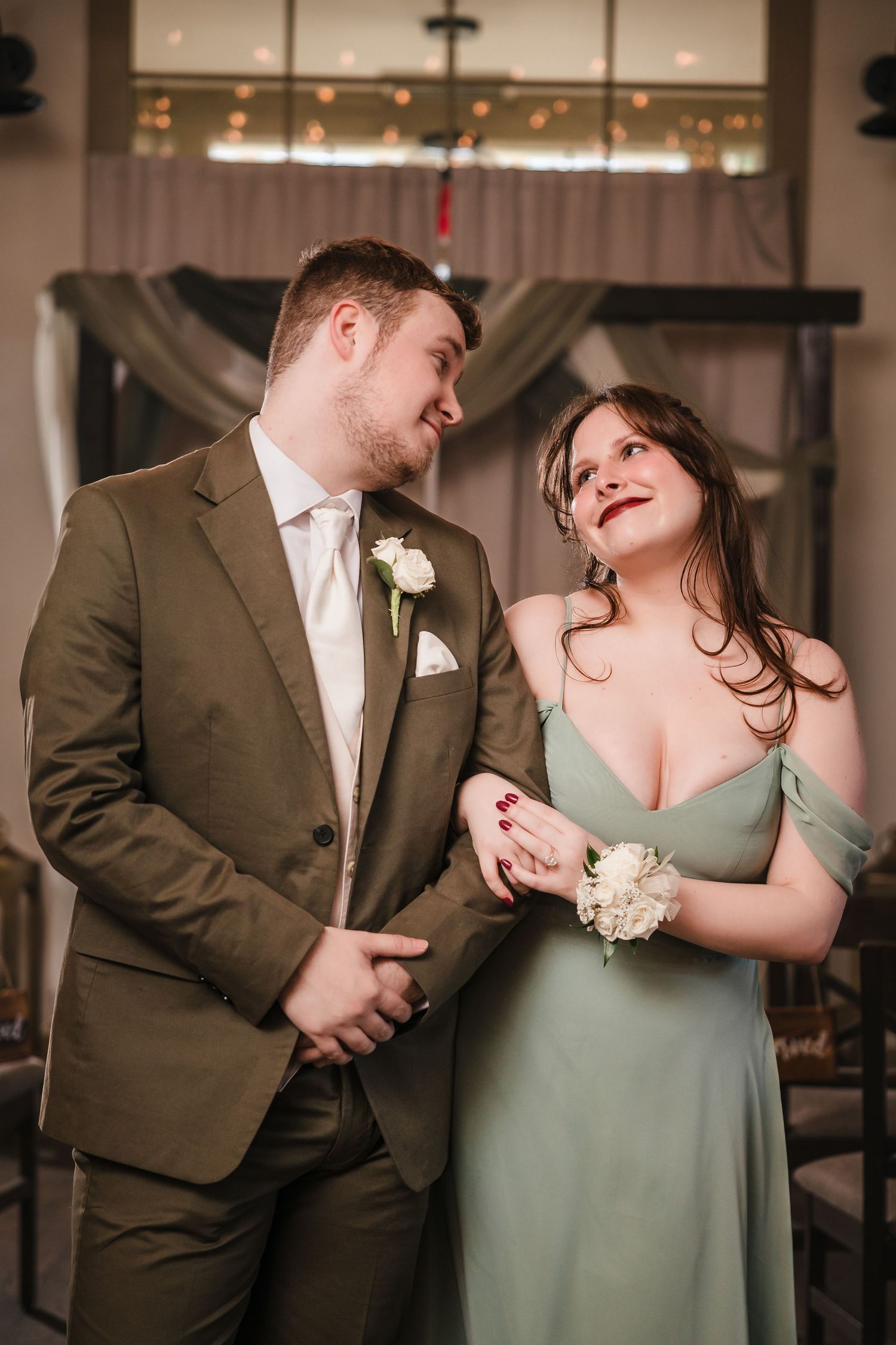 Romantic wedding party portrait inside Briar Barn Inn ceremony space with soft lighting and draped backdrop