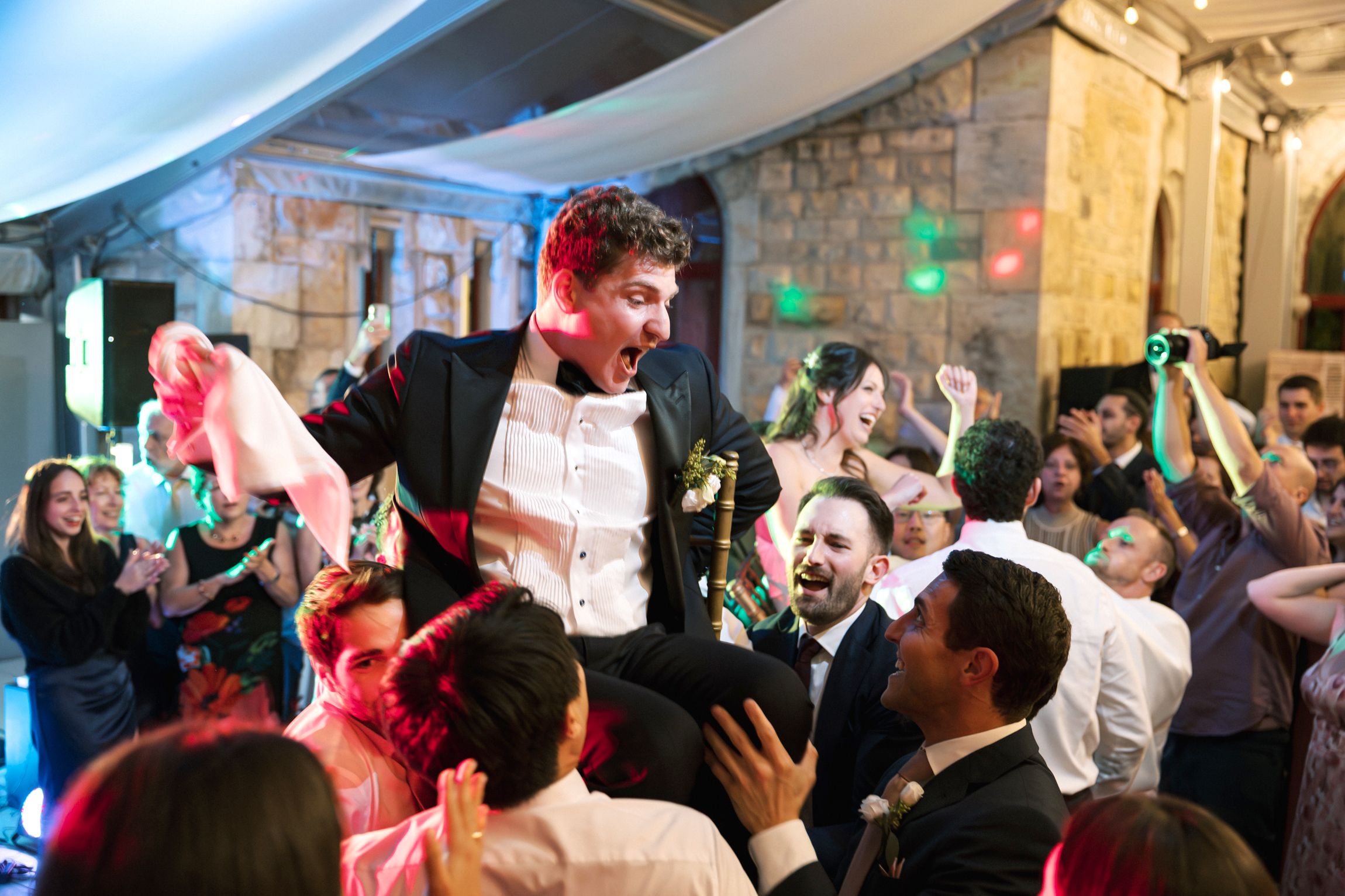 Traditional Jewish chair dance celebration during wedding reception in Cascais Portugal