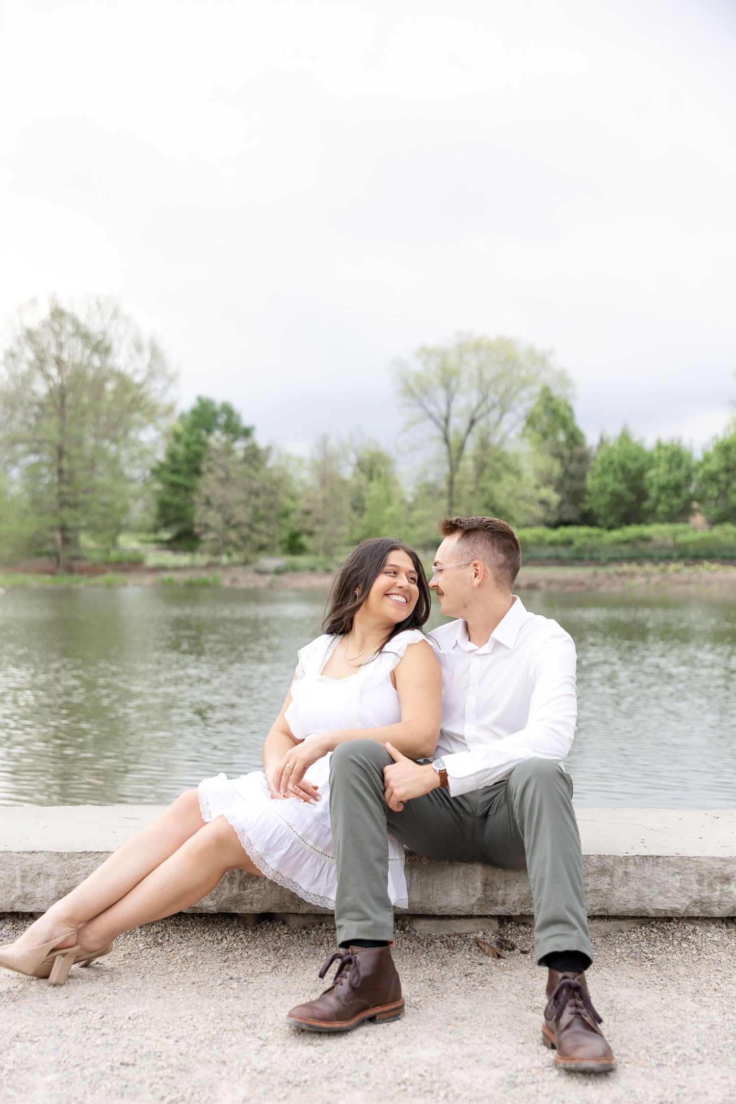 Engaged couple laughing together at Cox Arboretum in Dayton, Ohio during a joyful garden engagement session