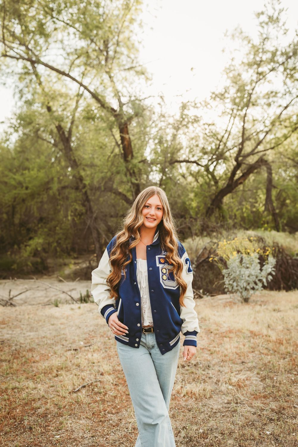 senior girl wearing a letterman's jacket for senior photos in redlands ca