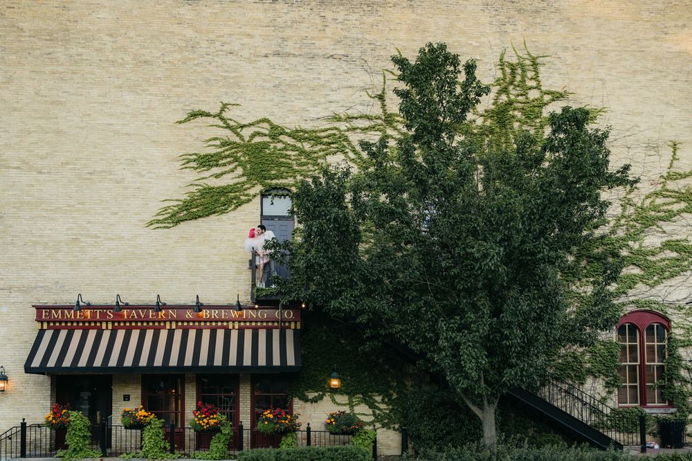 Couple during engagement session in front of Emmet's Tavern and Brewhouse in West Dundee