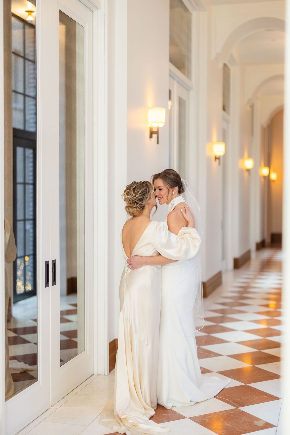 The Hallway at Shinola hotel, two bride embracing after their intimate ceremony in the Birdy room