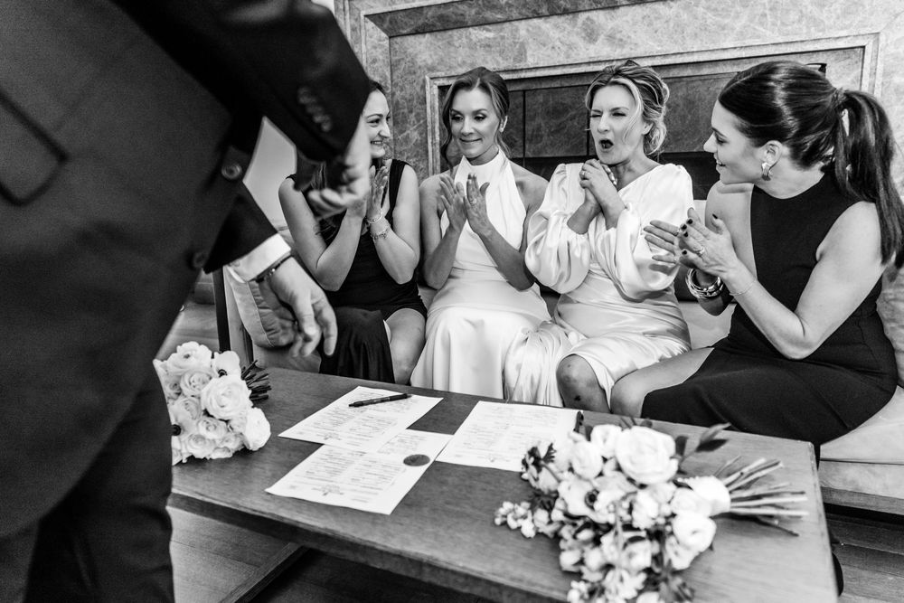 IT IS REAL! Signed sealed delivered, the brides sign their marriage license.