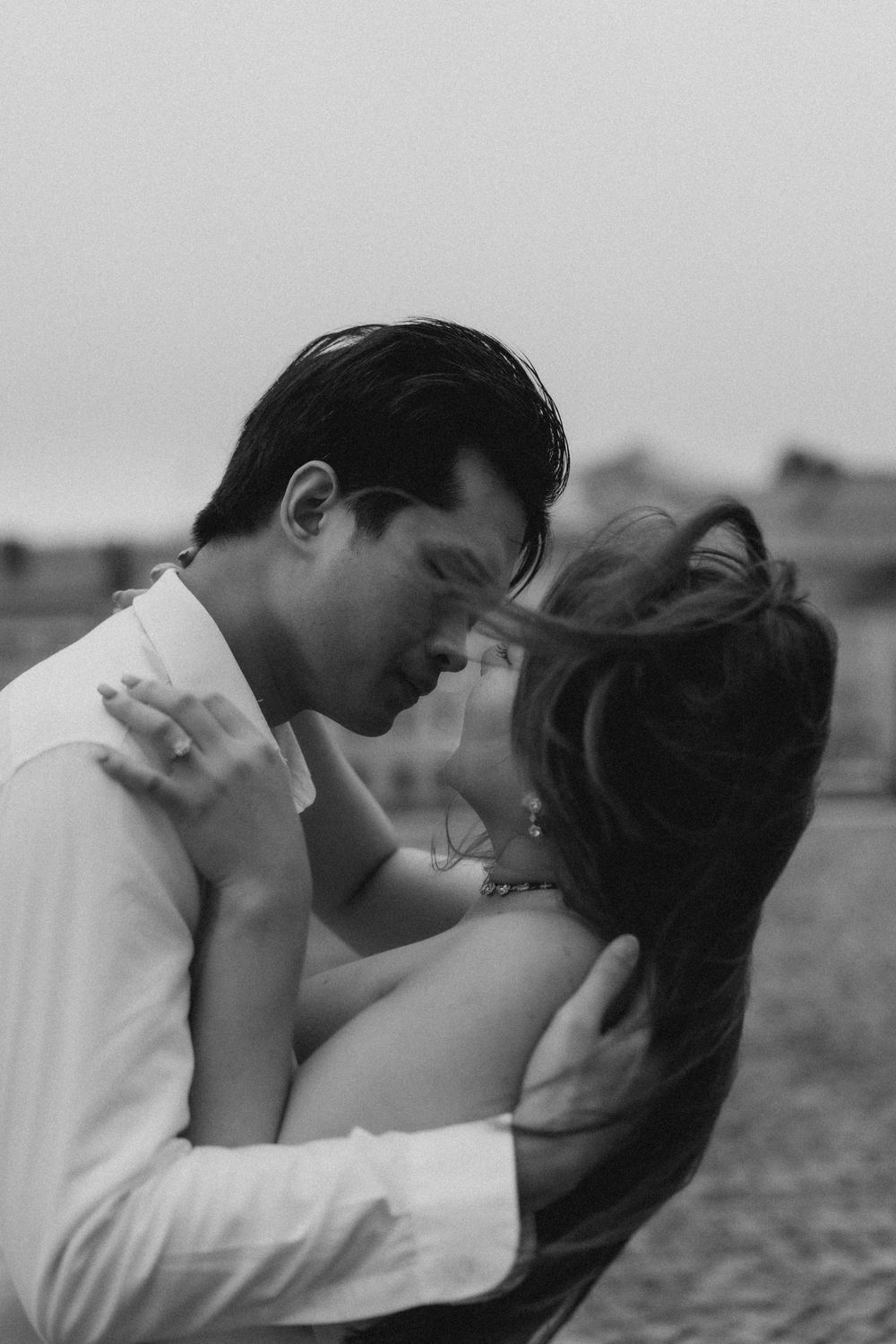 Black and white close-up of an engaged couple embracing during a natural Helsinki engagement session