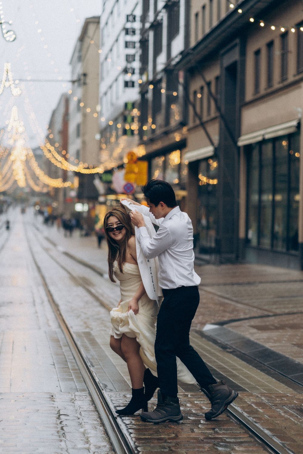 Engaged couple walking together through Helsinki city centre during an urban engagement photoshoot