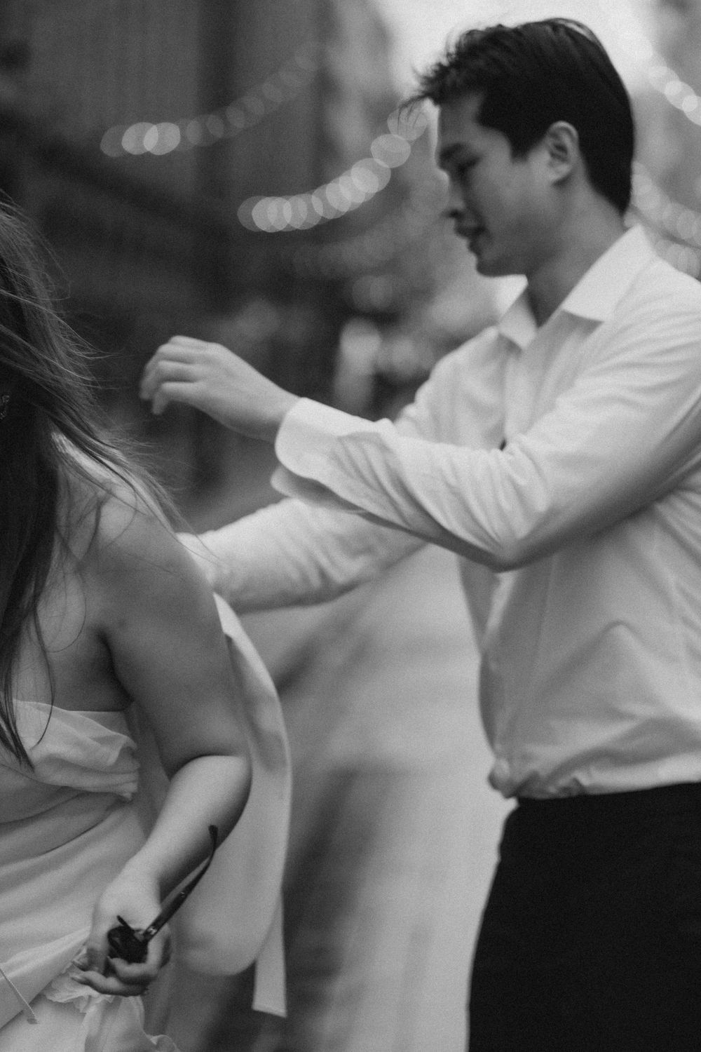 Black and white close-up of an engaged couple sharing a playful moment during a Helsinki engagement session