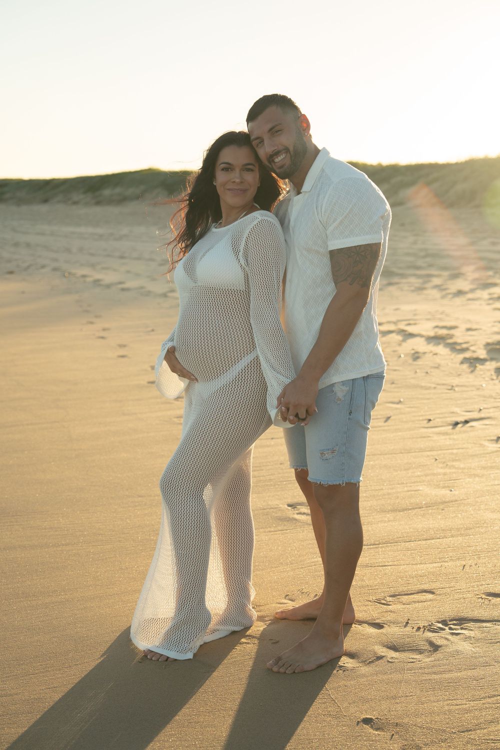 beach maternity photoshoot with soft golden light Wollongong coastline