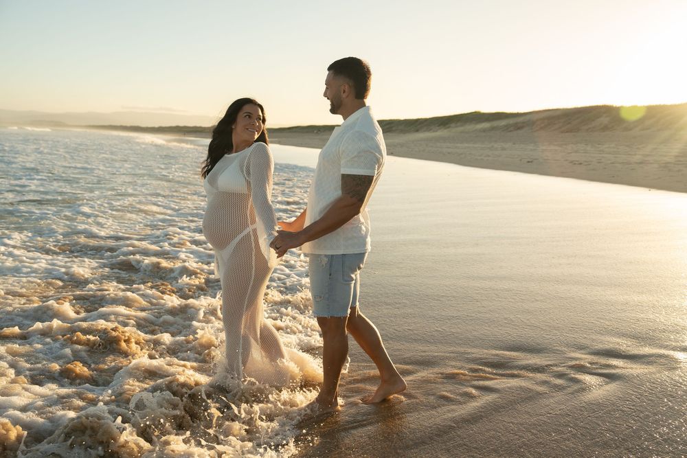 natural beach maternity session with soft tones and ocean views