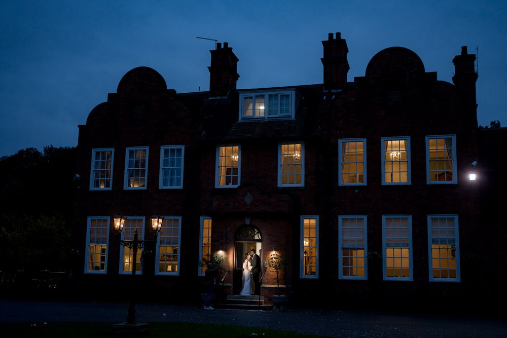 Bride silhouette in window Kelham House Country Manor at dusk Newark Nottinghamshire wedding photography