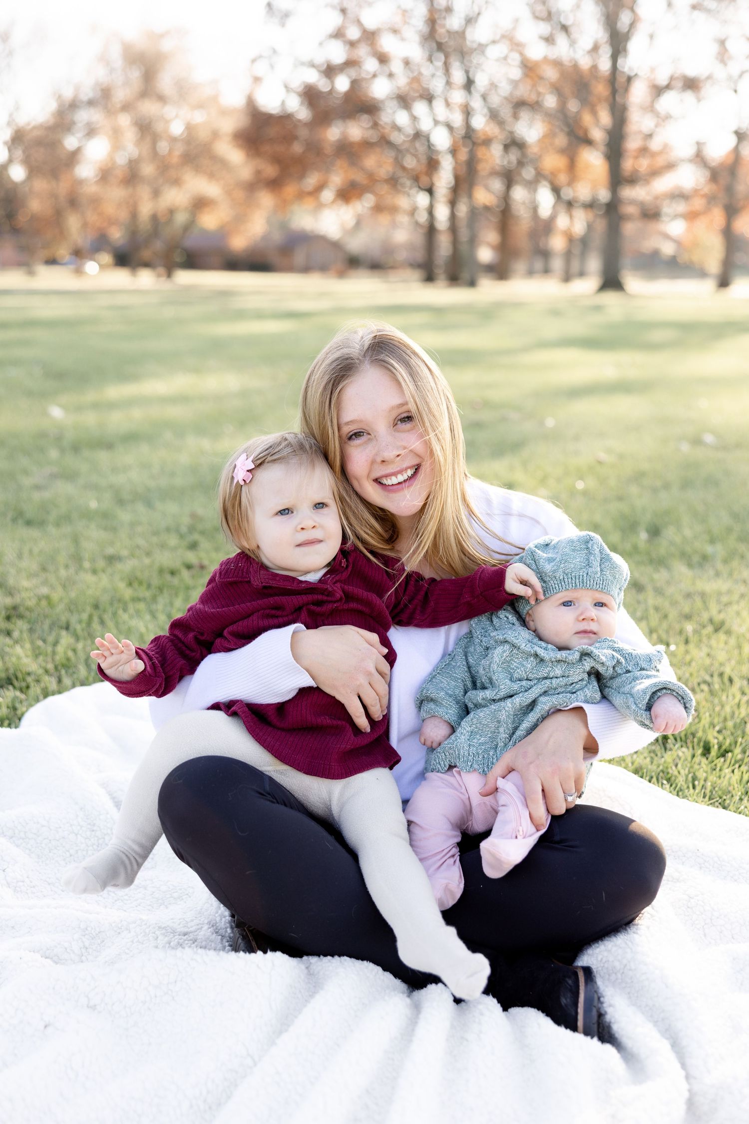 Joyful portrait of Julia from Julia and Sean Photography with her two daughters during a soft motherhood moment in Dayton Ohio