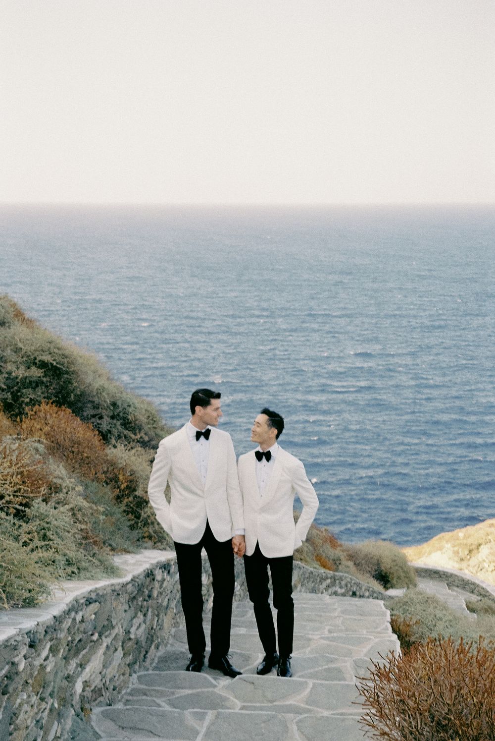 Same sex couple destination wedding LGBTQ+ photographer  looking the Aegean Sea in Sifnos