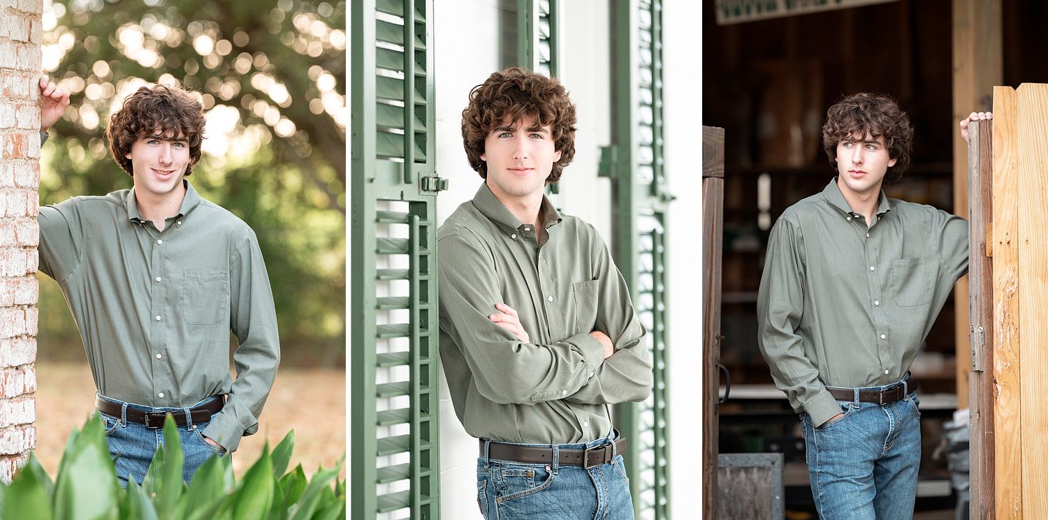 Teen boy in green shirt and jeans poses outdoors for senior portraits against rustic wooden backdrop.