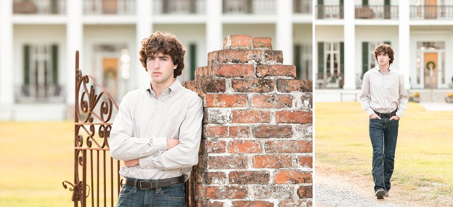Two young men posing outdoors near a brick pillar and iron gate in front of a large white Southern mansion.