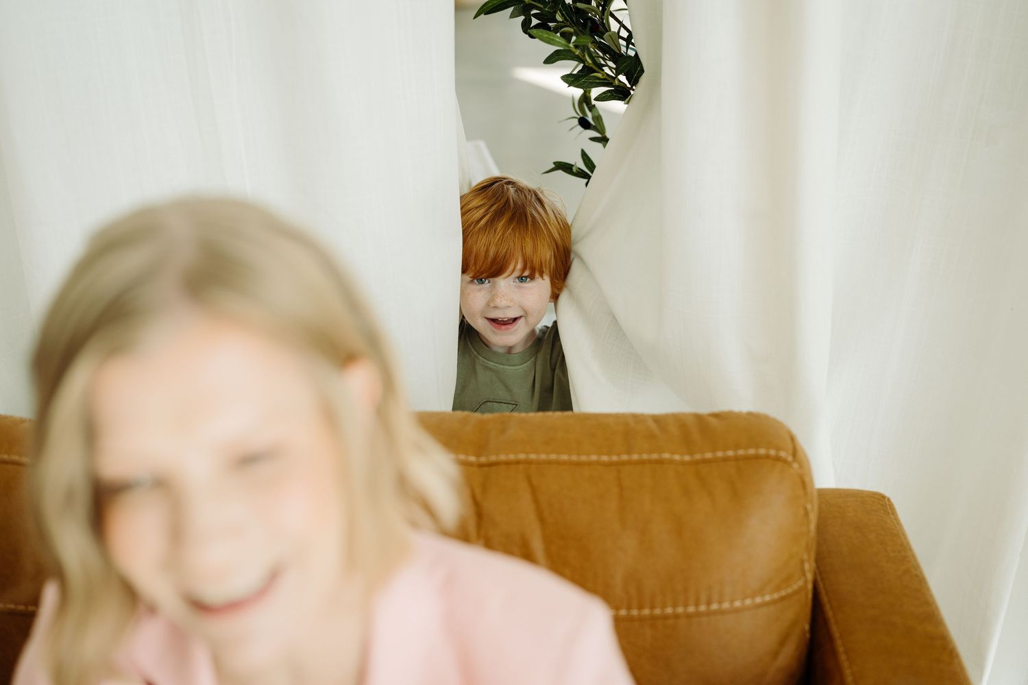 Angie's son peaks through the curtain while we were taking brand photos of Angie