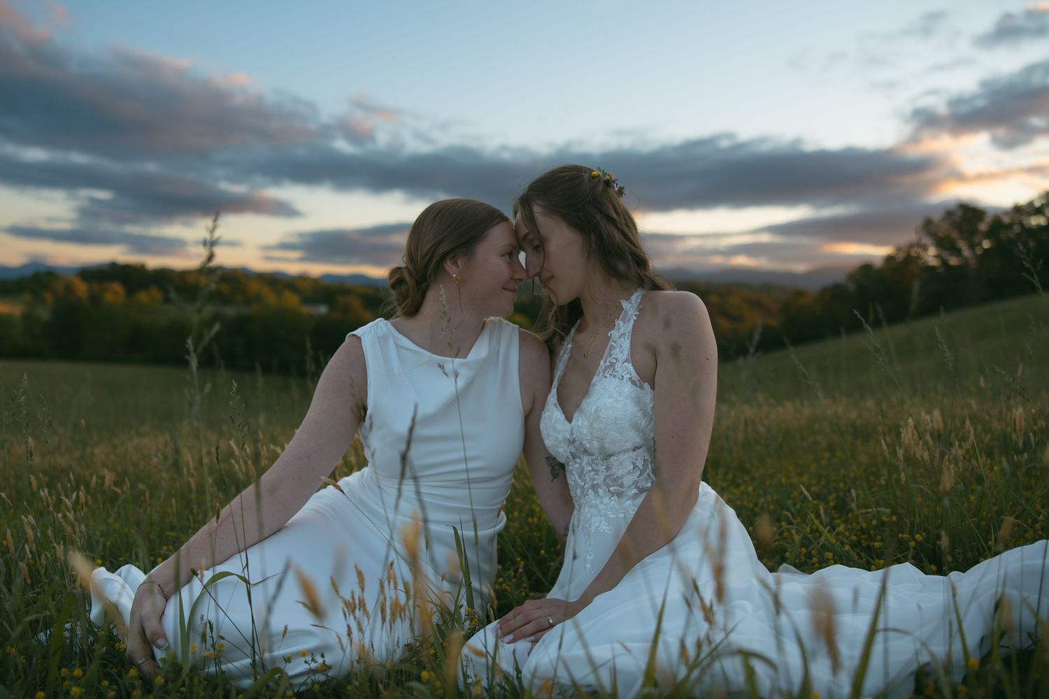 lesbian couple sitting together mountain view after wedding portraits asheville nc