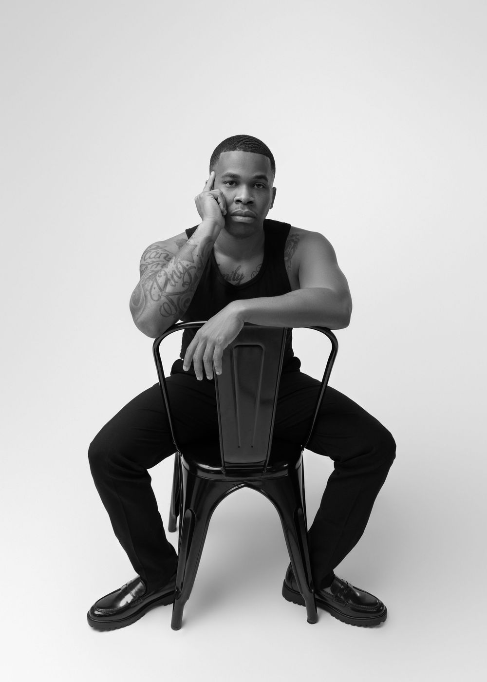Three black and white studio portraits show a seated person in casual attire against a minimalist white background.