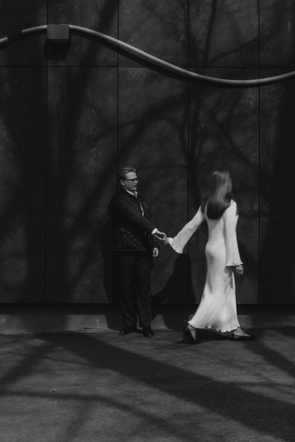 Engaged couple walking hand in hand during a cinematic engagement photography session in Helsinki