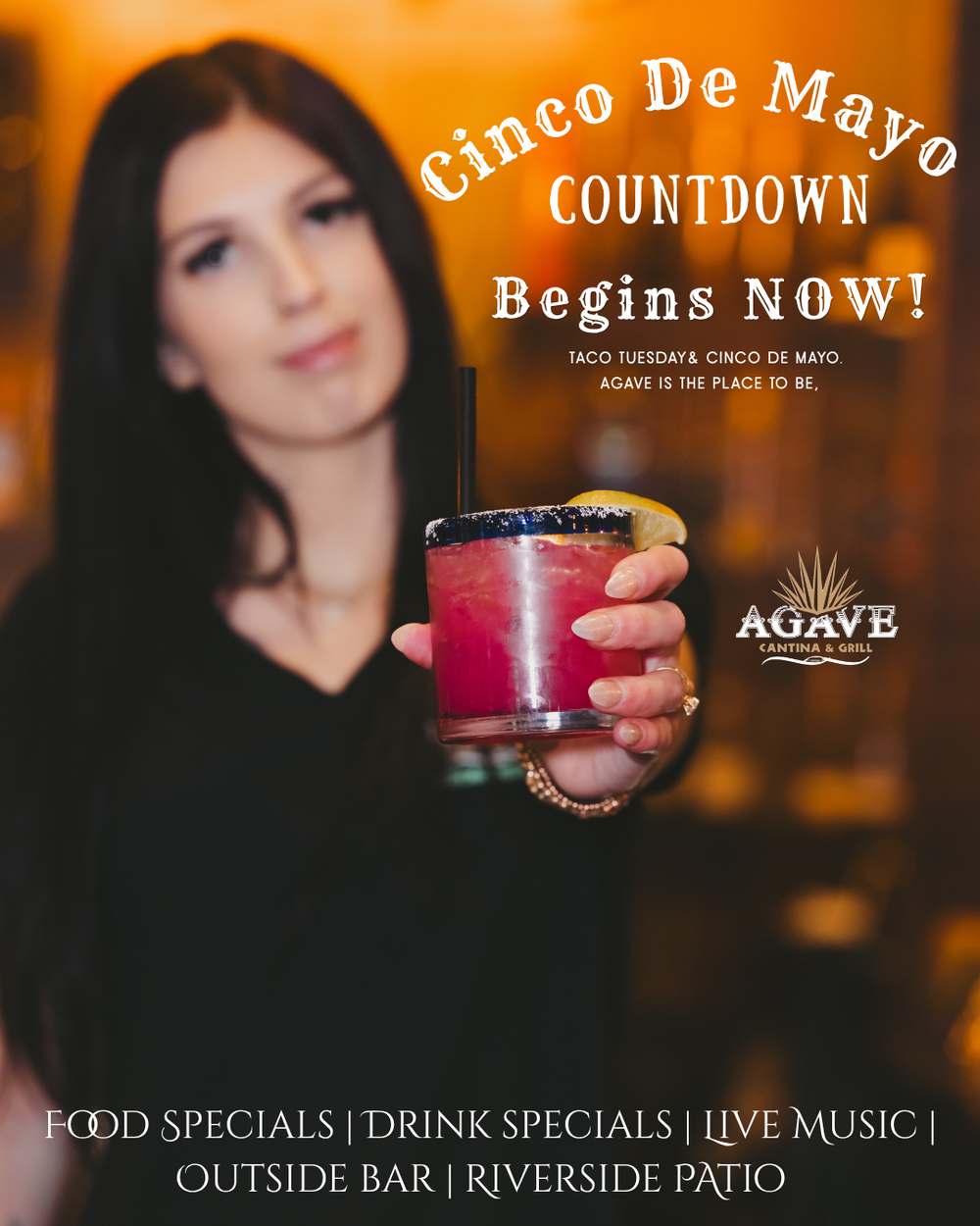 Bartender holding a pink cocktail for Cinco De Mayo at Agave Cantina with food and drink specials.