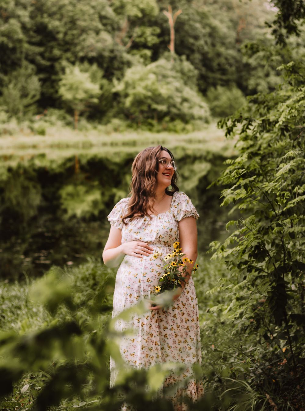 Expecting mother holding her growing belly in natural outdoor scenery in lewis county Washington