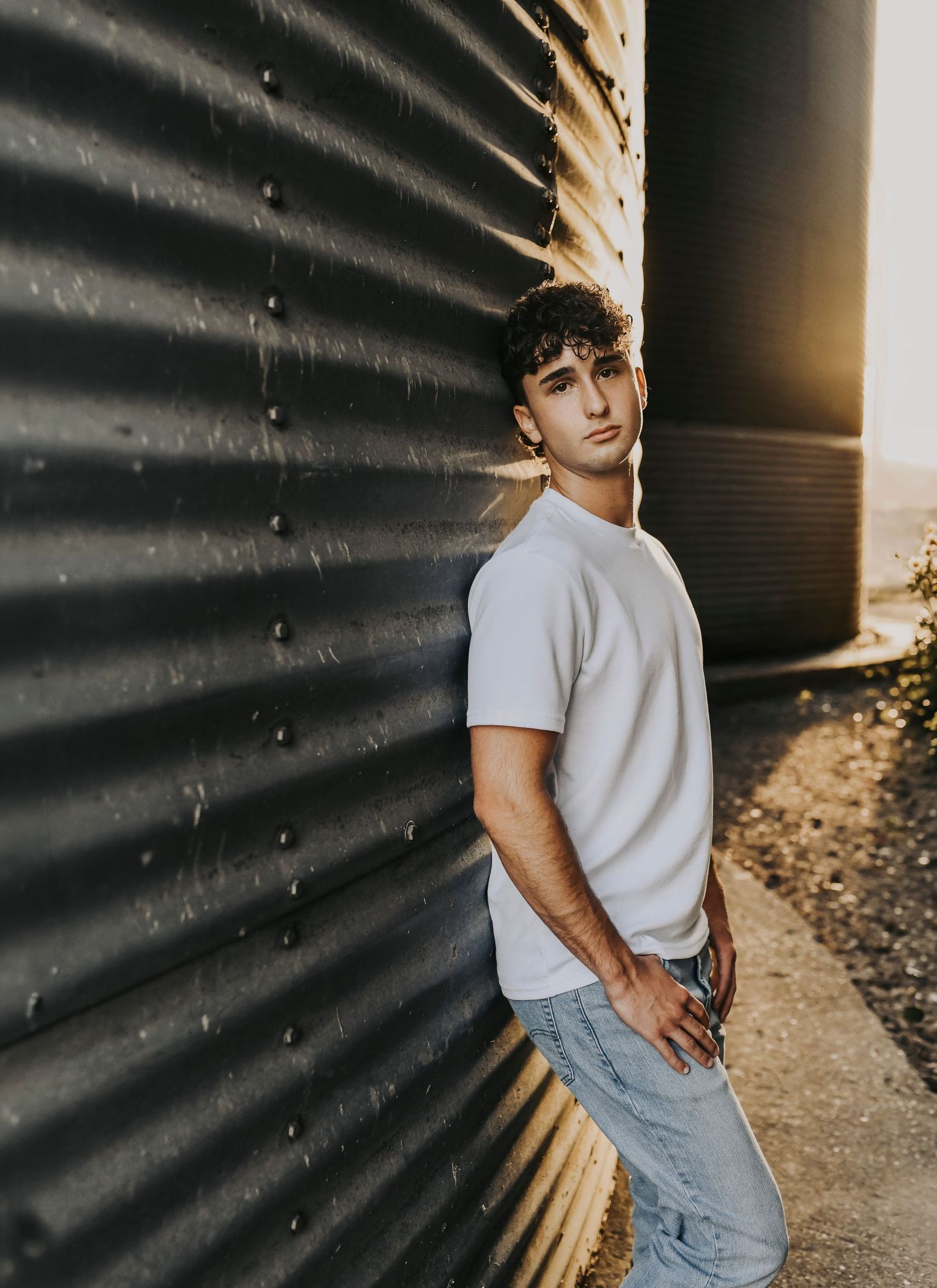 Rustic industrial senior photo session in McKinney Texas featuring classic fitted jeans and boots