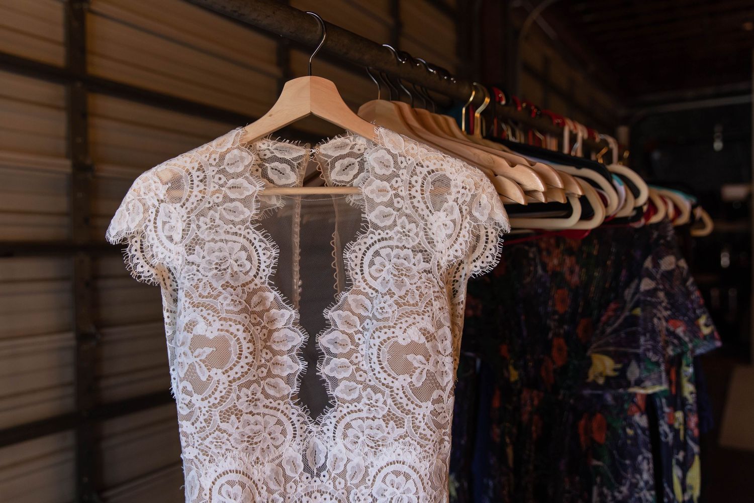 Photo of a wedding dress on a wooden hanger