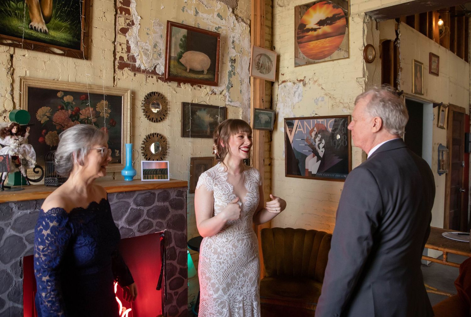 Photo of a bride with her parents, her Dad is seeing her in her wedding dress for the first time