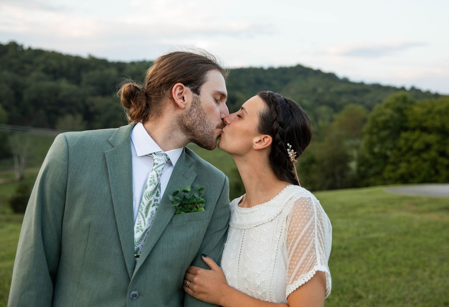 Photo of a bride and groom standing on a hill kissing. Abingdon, Virginia wedding photography