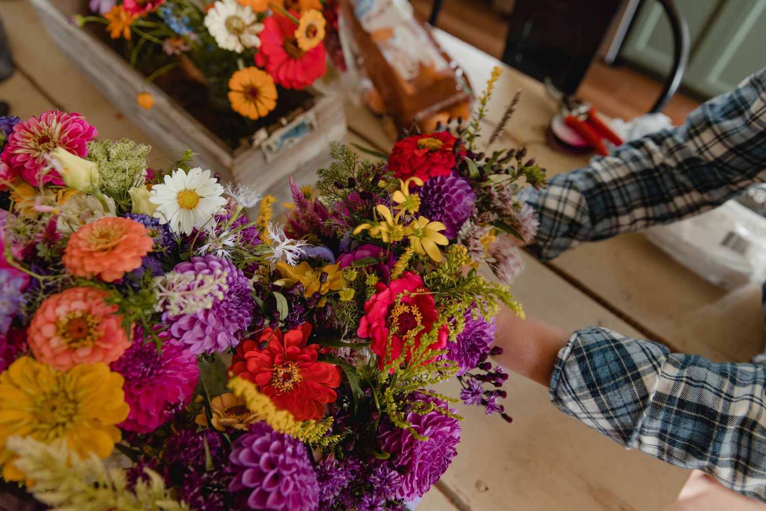 Photo of bridesmaids bouquets being assembled for a mountaintop wedding
