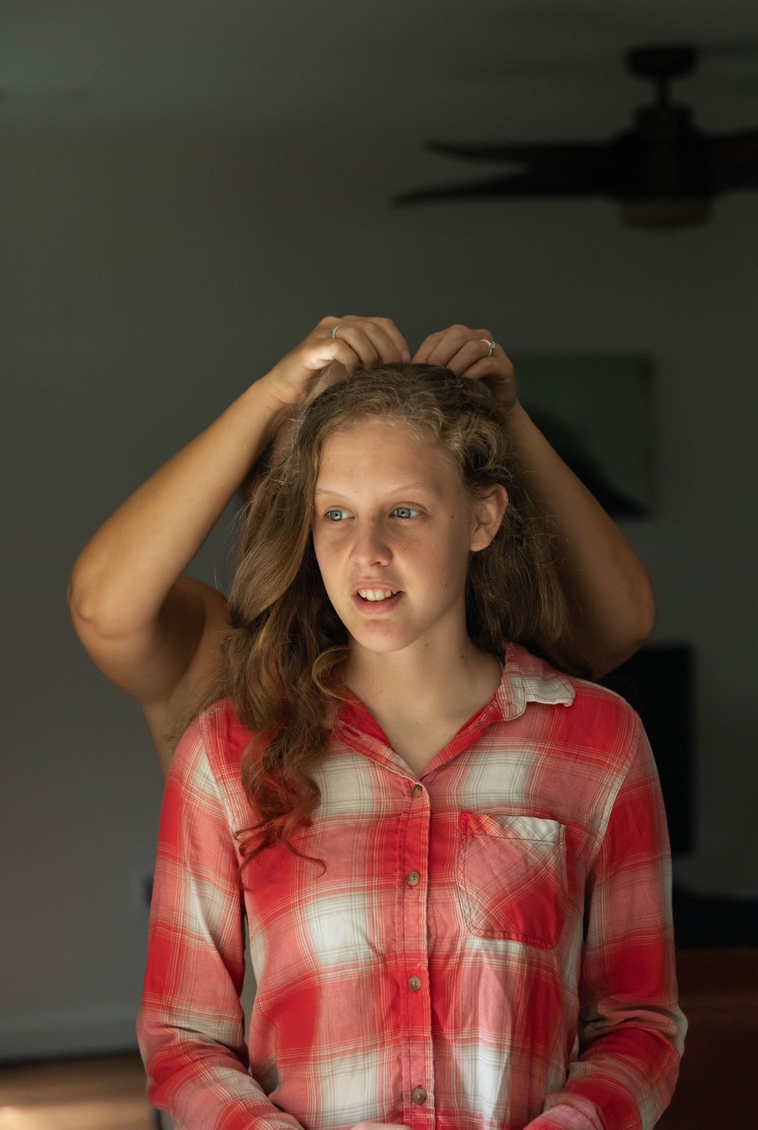 Photo of a bridesmaid having her hair braided for a mountaintop wedding