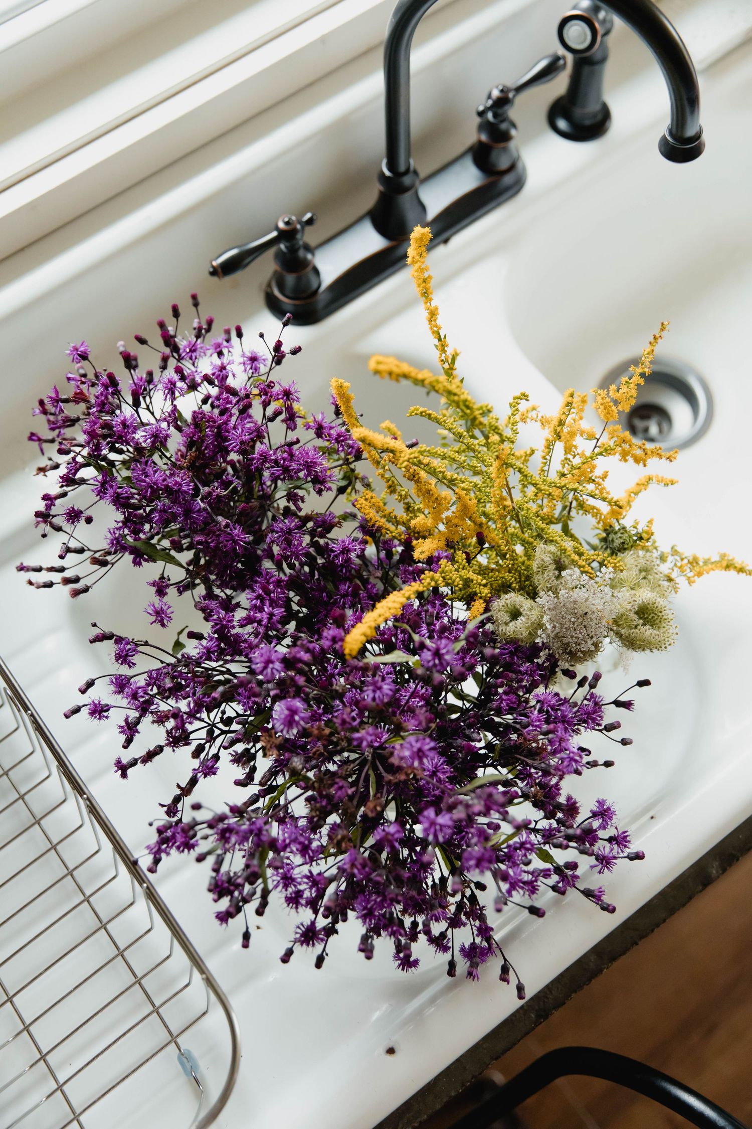 Photo of a flowers in a sink before being put into a bridal bouquet for a mountaintop elopement