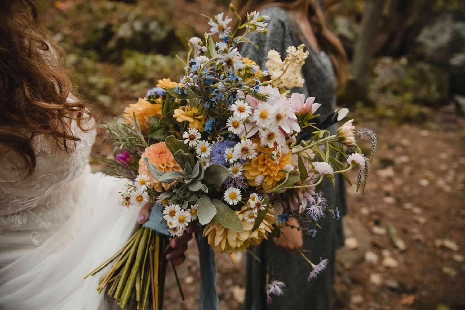 Photo of a bride holding a bouquet of wildflowers