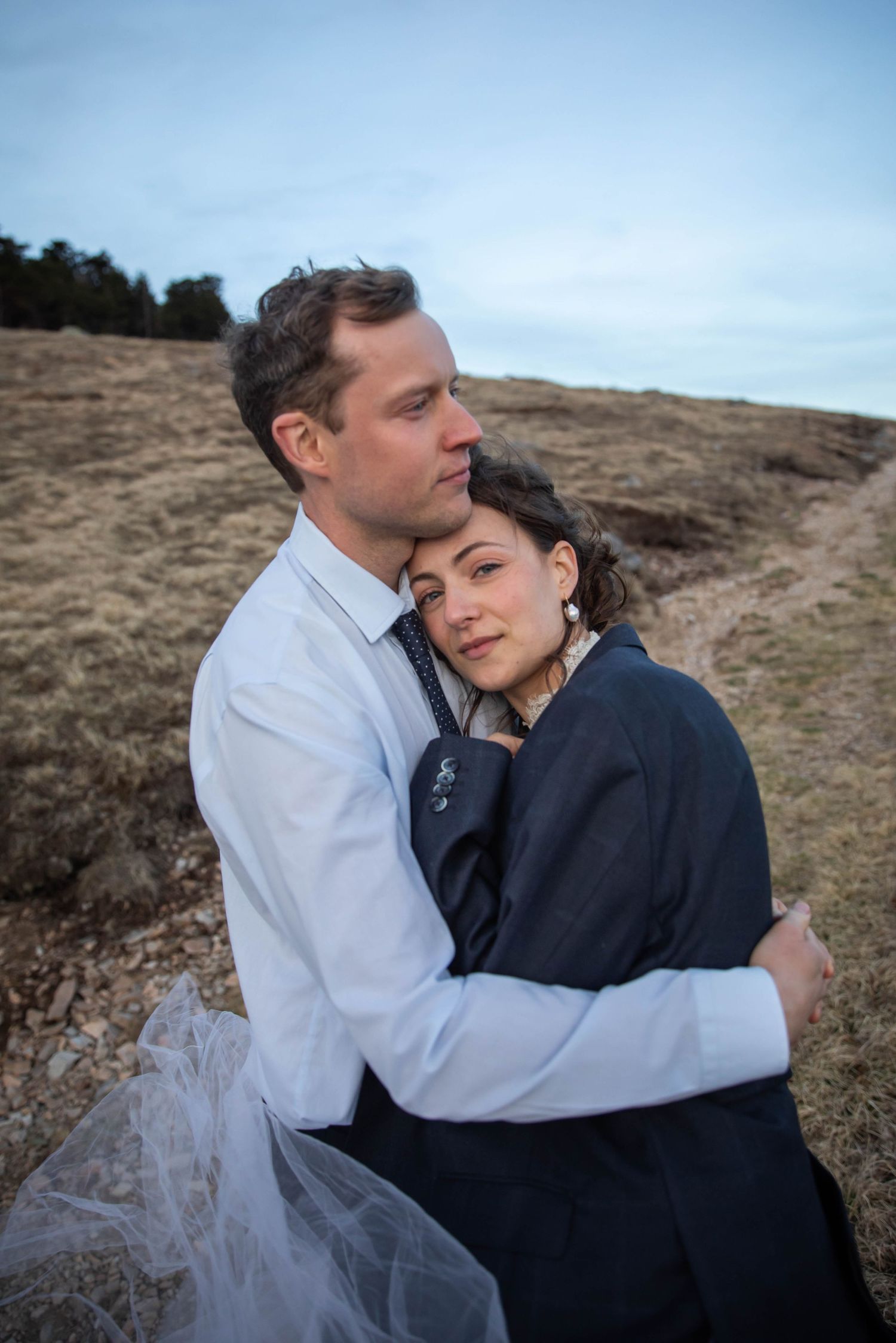 Photo of a bride and groom hugging on a mountaintop. Whitetop Mountain, Virginia elopement. Mountaintop bridal photos