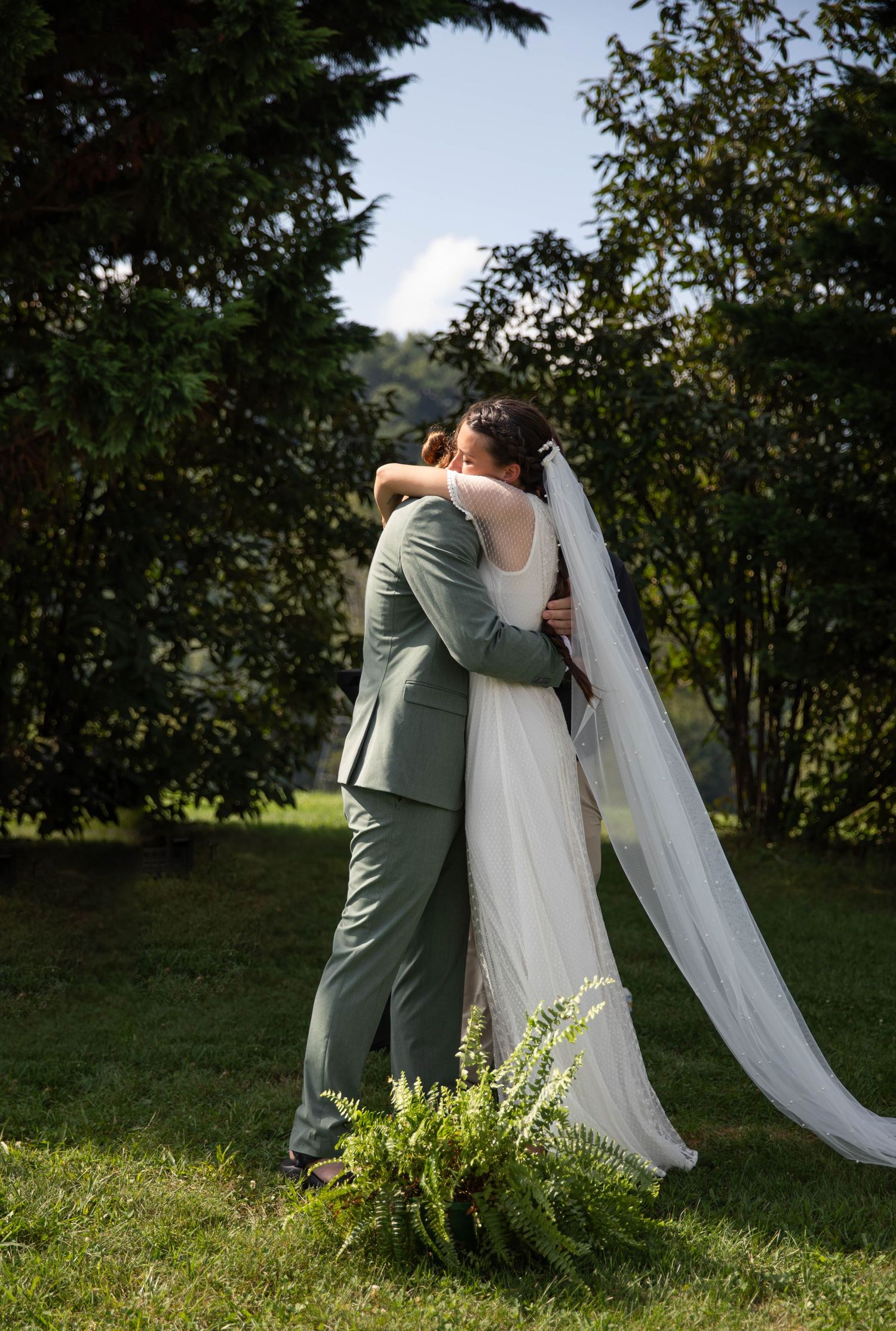 Photo of a bride and groom standing at the alter hugging one another after their first kiss. Abingdon, Virginia wedding photography