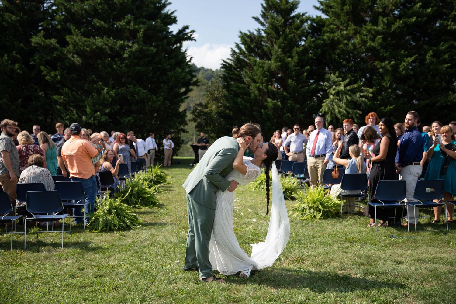 Photo of a bride and groom kissing after walking down the aisle. Abingdon, Virginia wedding photography