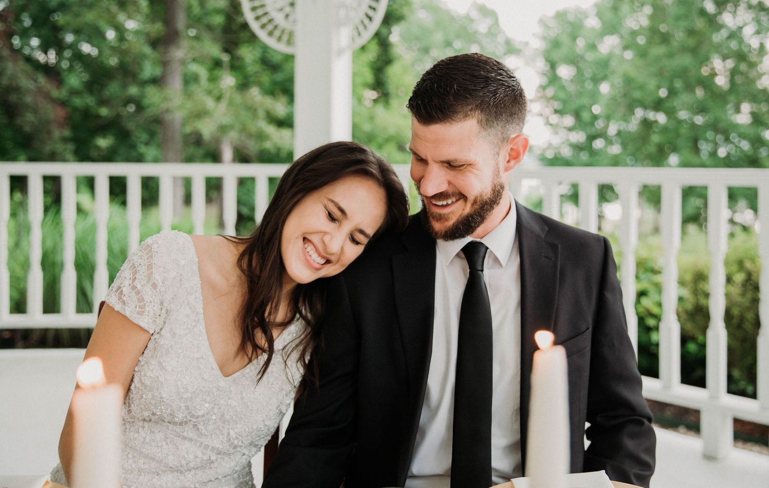 Photo of a bride and groom laughing during speeches