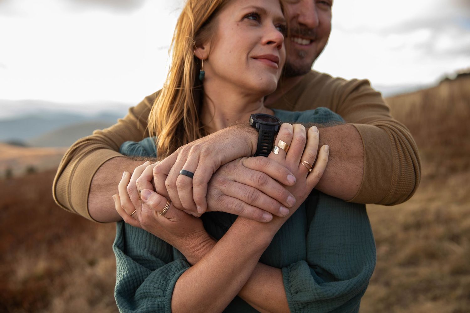 Photo of a couple loving on each other on Whitetop Mountain in southwest Virginia during a family photo shoot at sunset