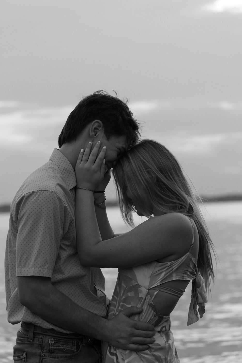 A romantic black and white photo sequence shows a couple embracing and kissing on a beach at sunset.
