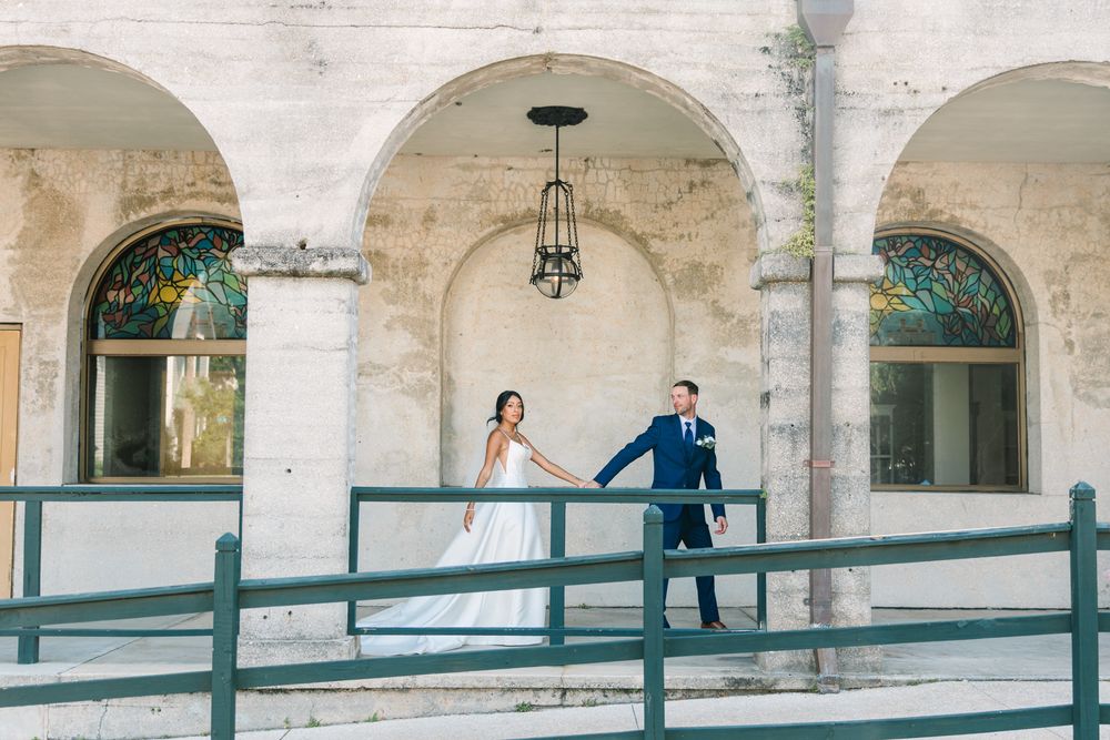 groom leading bride down hallway at lighter museum in st Augustine