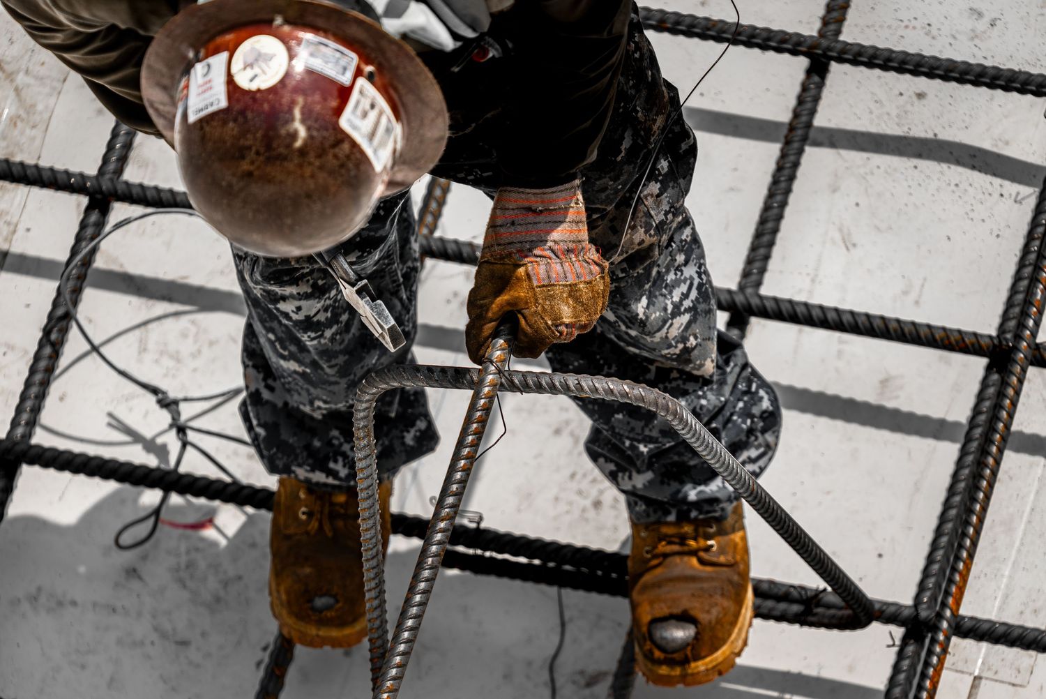 Close-up of steel rebar grid reinforcement being installed at construction site.